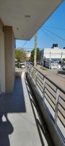 a shadow of a person on a sidewalk next to a building at El mejor lugar in Gualeguaychú