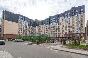 a large building with cars parked in front of it at Квартира в центре Астаны in Astana +3 photos