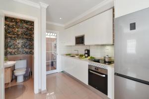 a white kitchen with a toilet and a sink at Chalet Santa Ana 15 by VillaGranCanaria in Playa del Ingles