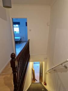 a hallway with a staircase in a house at (R0)2 Bedroom Flat in Zone 2 Lnd in London