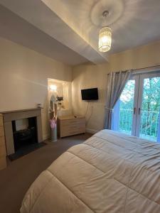 a bedroom with a large bed and a fireplace at Stackhouse flat in Burnley