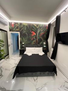a bedroom with a black bed and a wall mural at Suites - ghibellina 92 in Florence