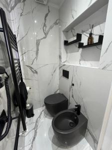 a bathroom with a black toilet and a sink at Suites - ghibellina 92 in Florence