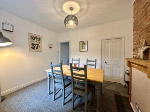 a dining room with a table and chairs at Waterloo Street in King's Lynn