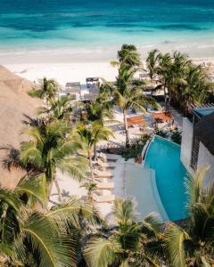 an aerial view of a resort with a pool and the beach at Gulliver condo - Free beach club access & Bikes in Tulum
