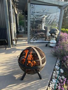 a fire pit sitting outside of a house at The shed with a view in Mahana