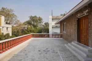 a balcony of a house with a wooden door at Elegant - 3BHK AC Villa with Lawn BanjaraHills HYD in Hyderabad