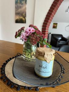 a vase of flowers sitting on top of a table at Penzion Harvanek in Vlachovice +54 photos