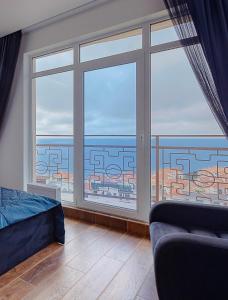 オデッサにあるSea Pearl Odesaのベッドルーム1室(海の景色を望む大きな窓付)