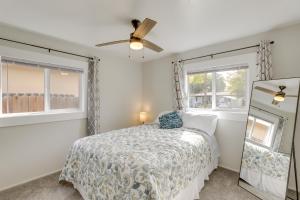 een slaapkamer met een bed en een plafondventilator bij Grand Junction Home with Deck about 2 Mi to Downtown! in Grand Junction