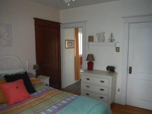 um quarto com uma cama e uma cómoda em Gîte Richmond Inn em Richmond