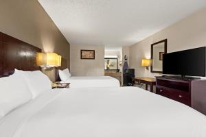 a hotel room with two beds and a flat screen tv at Americas Best Value Inn Laurel in Laurel