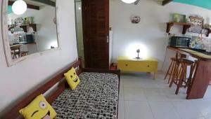 a living room with a mirror and a rug at Casa da Ale Buzios in Búzios