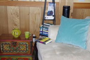 a living room with a white couch and a table with a blue pillow at Blitz Beach House Oceanside Suite in Powell River