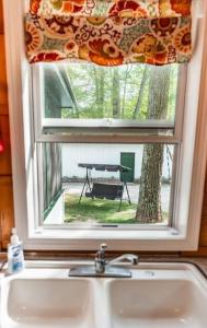 un lavandino da cucina con finestra sopra un lavandino da cucina di Big Blue Lake Cottages, LLC - Cottage #3 a Holton