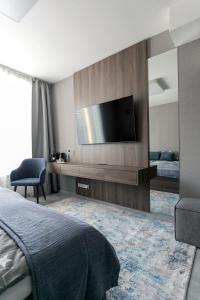a bedroom with a flat screen tv on a wall at LUONG Europe Apartments in Prague