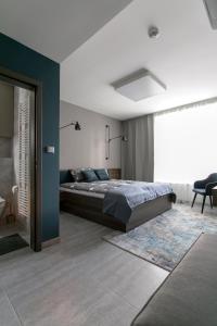 a bedroom with a bed and a blue wall at LUONG Europe Apartments in Prague