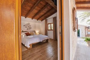 a bedroom in a house with a bed in it at Stunning Villa for 10 people with large heated pool-50m2, jacuzzi and gym - by TA Leut Agency in Privlaka +52 photos