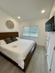 a bedroom with a bed and a flat screen tv at Modern Riverview Apartments in Fort Lauderdale