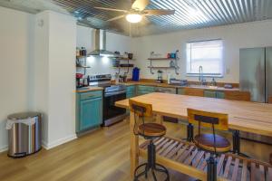 een keuken met een houten tafel en blauwe kasten bij Rustic Whitwell Home with Grill, Near State Parks! in Whitwell