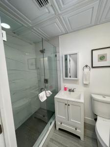 a bathroom with a glass shower and a sink at Modern Riverview Apartments in Fort Lauderdale