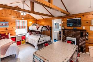 a bedroom with two bunk beds and a fireplace at Big Blue Lake Cottages, LLC - Cottage #4 in Holton