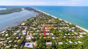 an aerial view of an island with a red arrow at Dancing Dolphin in Captiva