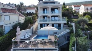 a villa with a swimming pool and a house at Villa Sonja Apartments in Krasici