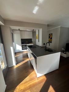 a kitchen with a black and white counter top at City Living Apartment München in Munich