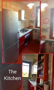 una cucina con frigorifero in acciaio inossidabile e armadietti rossi di Delponte Residence a Rocchetta Tanaro