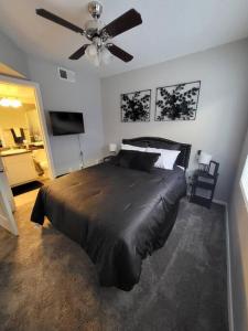 a bedroom with a bed and a ceiling fan at Modern 2BR Oasis! in Phoenix