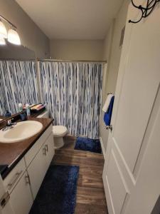 a bathroom with a sink and a toilet and a shower at Modern 2BR Oasis! in Phoenix
