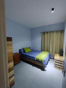 a bedroom with a bed and a dresser in it at Ashiana OceanSide Apartment in Flic-en-Flac