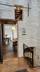 a living room with a table and a stone wall at CEP ECUYER in Brussels