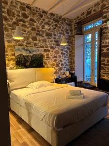 a bedroom with a large bed in a brick wall at Εn Kanaliois in Kanália