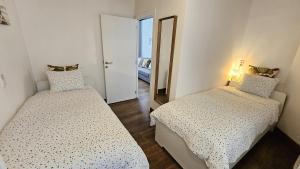 a small room with two beds and a mirror at CEP ECUYER in Brussels