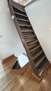 a wooden staircase in a room with a wooden floor at CEP ECUYER in Brussels