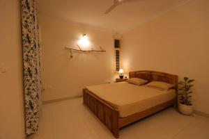 a bedroom with a wooden bed in a room at Soul'Stay- A HomeStay & Retreat Center in Agra