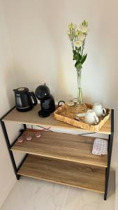 a shelf with a vase with flowers in it at La Maison des Crêtes in Parnans