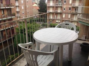 a white table and two chairs on a balcony at Relax time in Biella