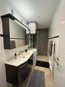 a bathroom with a sink and a mirror at Central Station Comfort, Your Cozy Home with free Parking in Salzburg