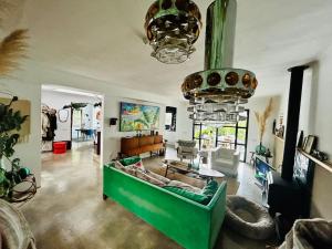a living room with a green couch in a room at Casa Viva Begur in Begur