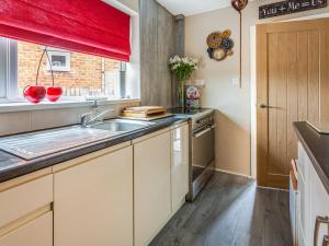 a kitchen with a sink and a window at Tean House in Totmonslow