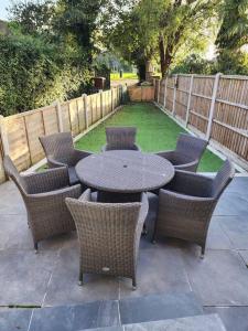 a patio with a table and chairs and a fence at Beautiful 3 bed house in Hartford in Hartford