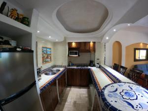 a kitchen with a large counter top in a room at Oceanview Condo Vela Vallarta condo in Puerto Vallarta