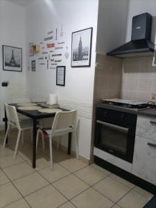a kitchen with a table and a stove at La Villetta in Rende