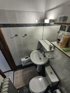 a small bathroom with a toilet and a sink at Antigoni's Urban Elegance Escape in Ioannina