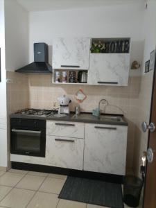 a kitchen with a stove and a sink at La Villetta in Rende