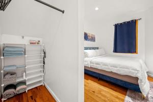 a small bedroom with a bed and a closet at Charming Home In Heart of City With King Size Bed! in Philadelphia