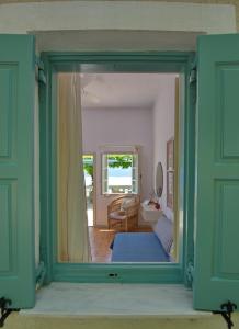 a view of a bedroom through a glass door at Casa Kalypso in Steni Vala Alonissos